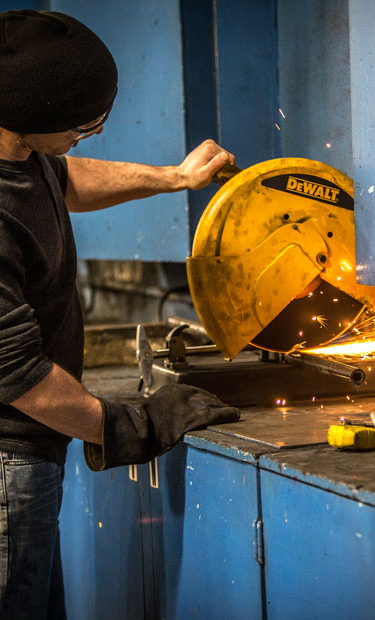 Man sawing metal pipe